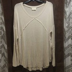Flowing long sleeve with rough-hewn details
